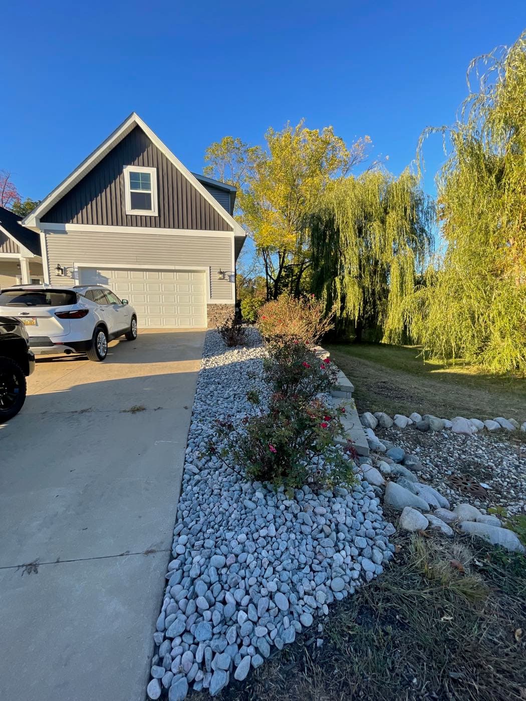 Crisp fall landscaping with red-leafed shrubs and stone edging